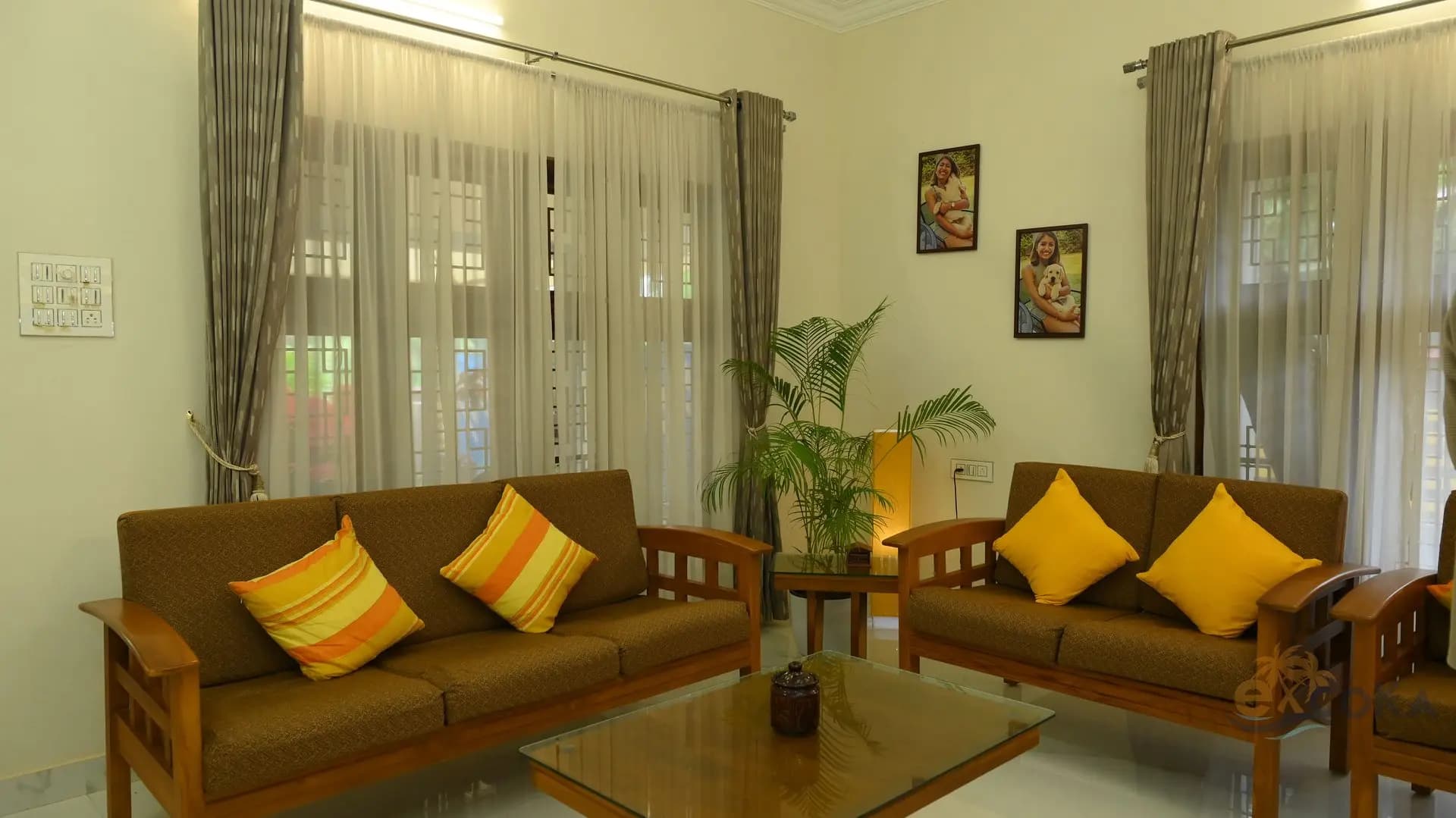 Sunlit living room with wooden sofas