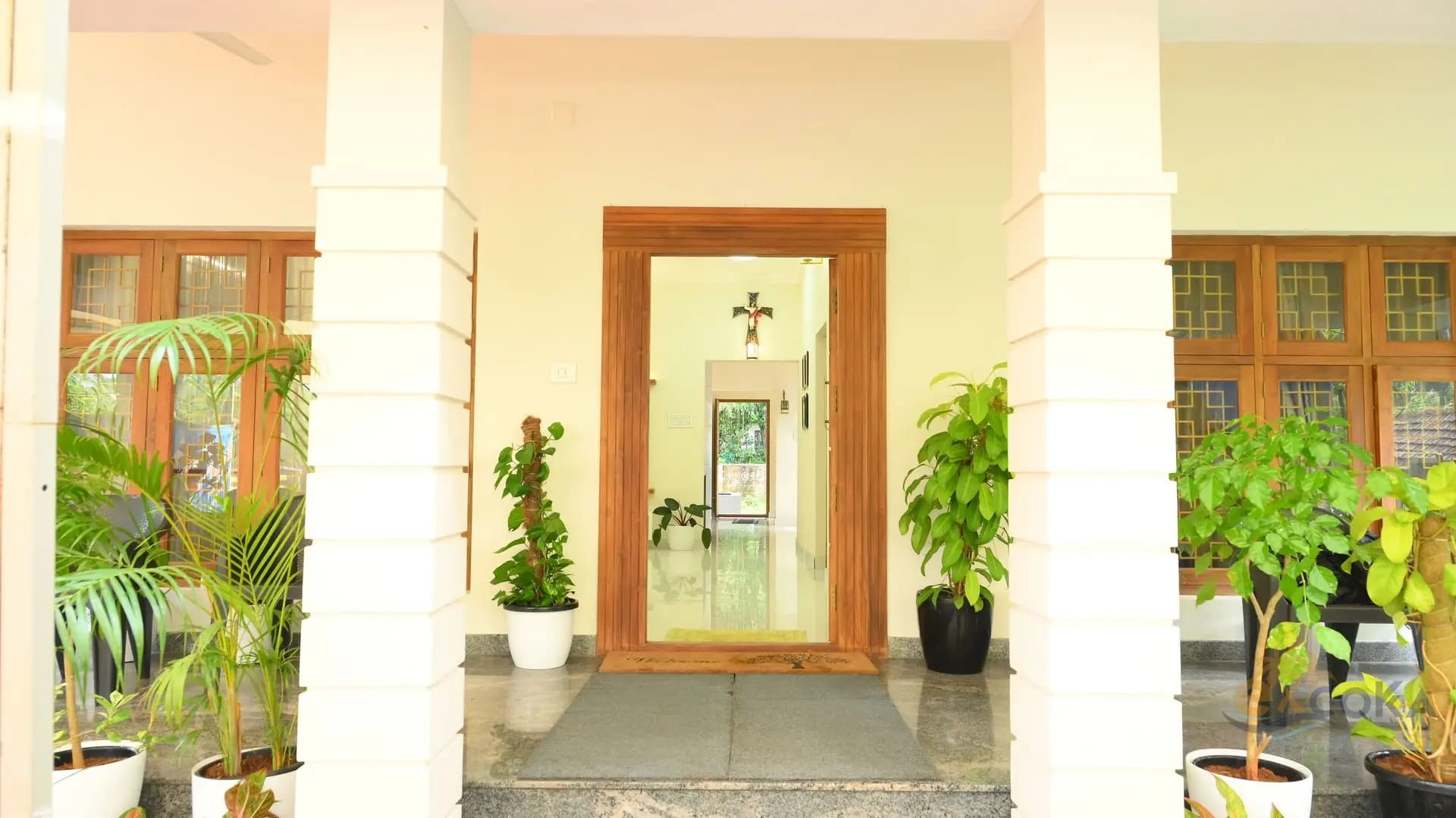 Welcoming entrance framed by potted greenery